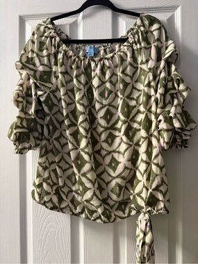 CeCe blouse features a green and white geometric pattern with ruffled sleeves